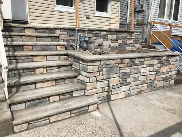 Stone entrance steps, veneer, and masonry wall from AJT’s project gallery