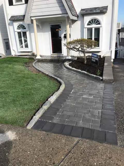 Curved paver walkway leading to a home from AJT’s project gallery